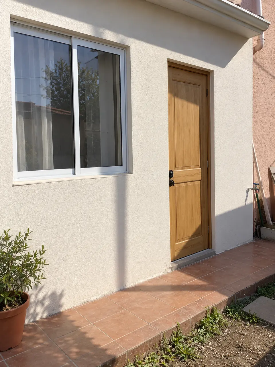 Imagen referencial de fachada renovada con puerta de madera y ventana de aluminio